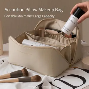 Large beige leather makeup organizer bag with multiple compartments and luxury design