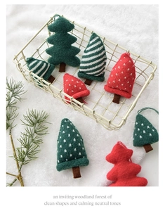 Detail of knitted Christmas tree ornaments in red and green colors with fine texture