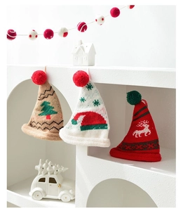 Detailed knit texture of mini Christmas pom pom hats for tree and bottle decorations