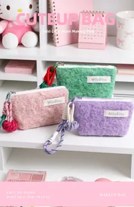 Close-up of fluffy macaron-colored plush coin purses with braided lanyards and zippers