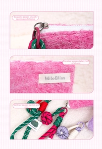 Detail view of pink plush pouch with white resin zipper and colorful woven charm