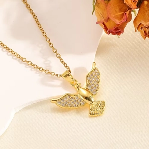 Macro shot of gold pony pendant with inlaid zircons on a textured cream fabric background
