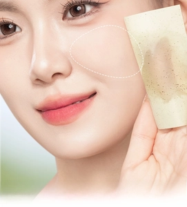 Close-up of portable facial oil blotting paper removing excess oil for a matte look