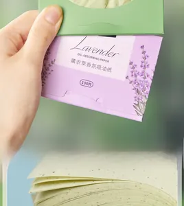 Macro view of lavender oil blotting sheets showing paper texture and purple floral box