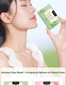 Detailed close-up of green tea facial oil blotting paper in portable packaging with 100 sheets