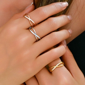 Crossed X stainless steel rings in gold, silver, and rose gold with micro-pave crystals