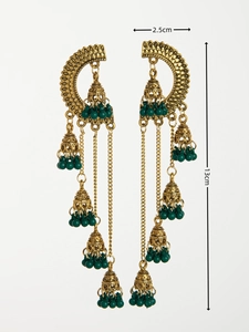 Detail view of vintage Indian jhumka earrings with hollow metalwork and green beads