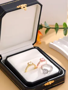 Detailed view of three halo rings in gold rose gold and silver within a premium jewelry box