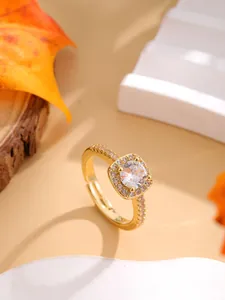 Macro shot of halo setting ring with round center stone and adjustable gold band