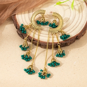 Exaggerated vintage Indian Jhumka earrings with hollow crescent and green bead tassels