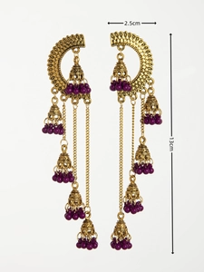 Detail view of gold Indian style long tassel earrings with purple beads and size markings