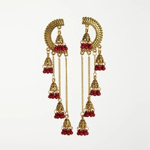 Detail of vintage gold Indian Jhumka earrings with red beads and tiered bell tassels