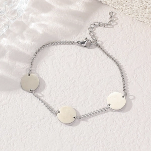 Polished stainless steel bracelet with three round charms and adjustable lobster clasp closure