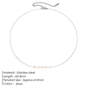 Macro detail of stainless steel necklace featuring five horizontal freshwater pearls