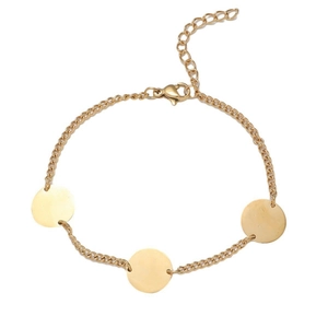 Detail of gold chain bracelet with three circular metal tags and adjustable lobster clasp