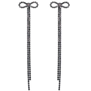 Macro view of long bow knot drop earrings featuring elegant black rhinestone tassels