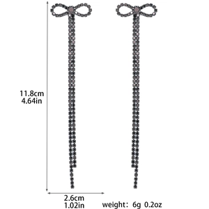 Detail view of long bowknot tassel earrings with grey rhinestones and exact dimensions