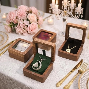 Walnut wood jewelry box with window lid and heart necklace on a romantic table setting