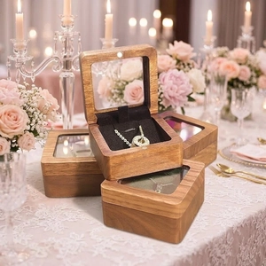Detail view of walnut jewelry box with glass window and necklace on elegant lace cloth