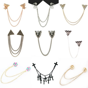 Detail of nine distinct suit brooch designs featuring gold leopard, skulls, and tassels