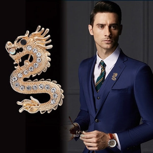 Macro view of gold dragon brooch with sparkling rhinestones on formal suit jacket