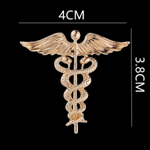 Detailed view of golden caduceus brooch with precise measurements showing 4cm width