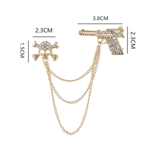 Detail of crystal skull and pistol suit brooch with gold chains and measurements