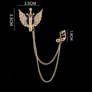 Detailed view of gold wing sword brooch with crystal tassel chains and musical note charm