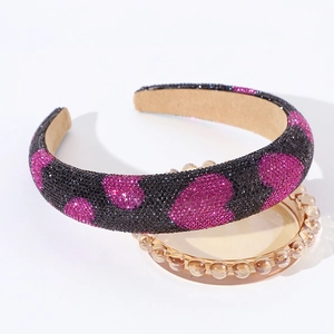Detail view of padded rhinestone headband with pink hearts and anti-slip lining