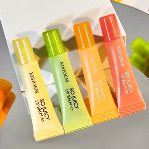 Glossy mirror lip balm set with four vibrant shades on a reflective white pedestal