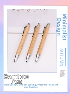 Detailed close-up of three bamboo ballpoint pens with silver metal clips and push buttons