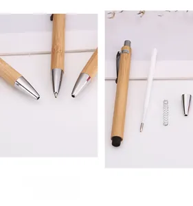 Detailed exploded view of a bamboo ballpoint pen showing internal refill and spring parts