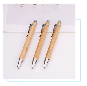 Detailed view of three eco-friendly bamboo ballpoint pens with polished metal accents