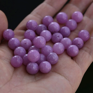 Close-up of polished purple round natural stone beads for DIY jewelry and bracelets