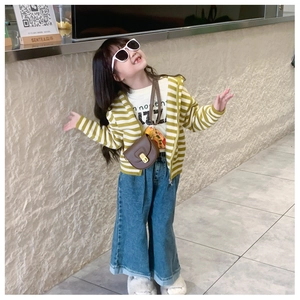 Kid girl wearing a striped hooded cardigan with a brown saddle crossbody bag