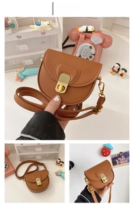 Detail of a brown leather saddle bag for girls with a vintage gold metal push-lock