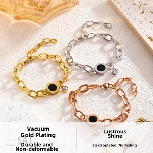 Detailed view of three-tone Roman numeral chain bracelets with crystal and black disc