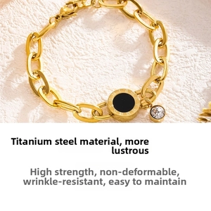 Detailed macro view of gold-plated titanium steel chain bracelet with Roman numerals and zircon