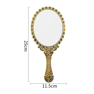 Vintage style gold handheld vanity mirror with ornate embossed details 25x11.5cm