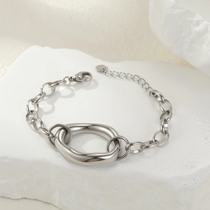 Detailed close-up of a minimalist silver geometric metal bracelet with lobster clasp