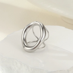 Close-up of geometric wave ring with multilayered band on a white stone base