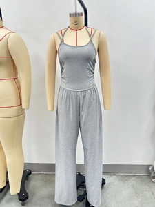 Detail of grey strap wide leg jumpsuit showing knitted texture and smocked bust design
