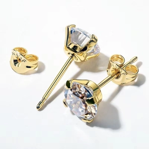 Macro view of four-prong gold-plated stainless steel stud earrings with brilliant round zircon