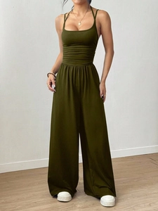 Detail of olive green high-waisted wide leg jumpsuit with backless halter neckline