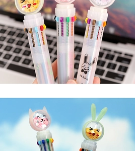 Detail of multi-color retractable pen featuring 10 inks and cute sequin cartoon topper