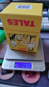 Family Edition card game boxed set showing 304.13g weight on a digital scale
