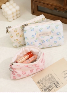 Detail of floral lace makeup bags in blue pink and yellow colors for travel storage