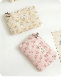 Close-up of floral zipper pulls and lace texture on aesthetic cosmetic pouches