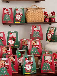 Detailed Christmas gift boxes with plush toys and ceramic mugs in festive display