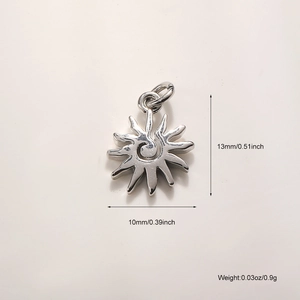 Macro view of sun charm pendant with spiral pattern and 13mm by 10mm dimensions